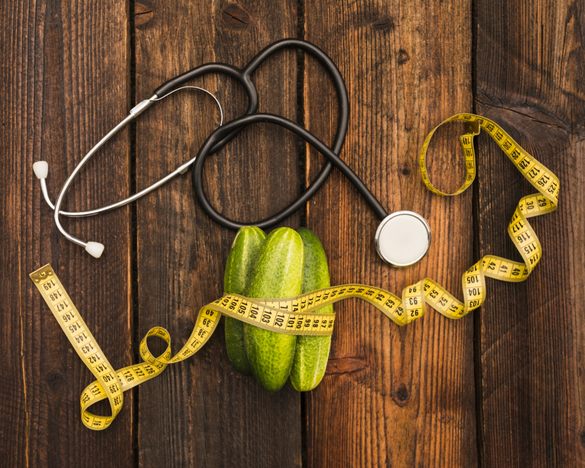 cucumbers-measuring-tape-stethoscope-wooden-surface.jpg 